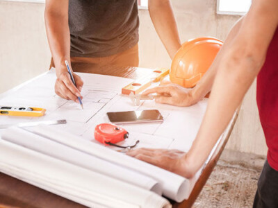 construction worker looking over blueprints