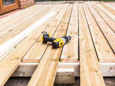 drill laying on the wooden porch of a home